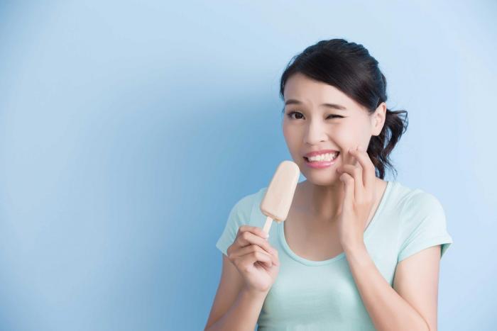 Girl with sensitive teeth from popsicle
